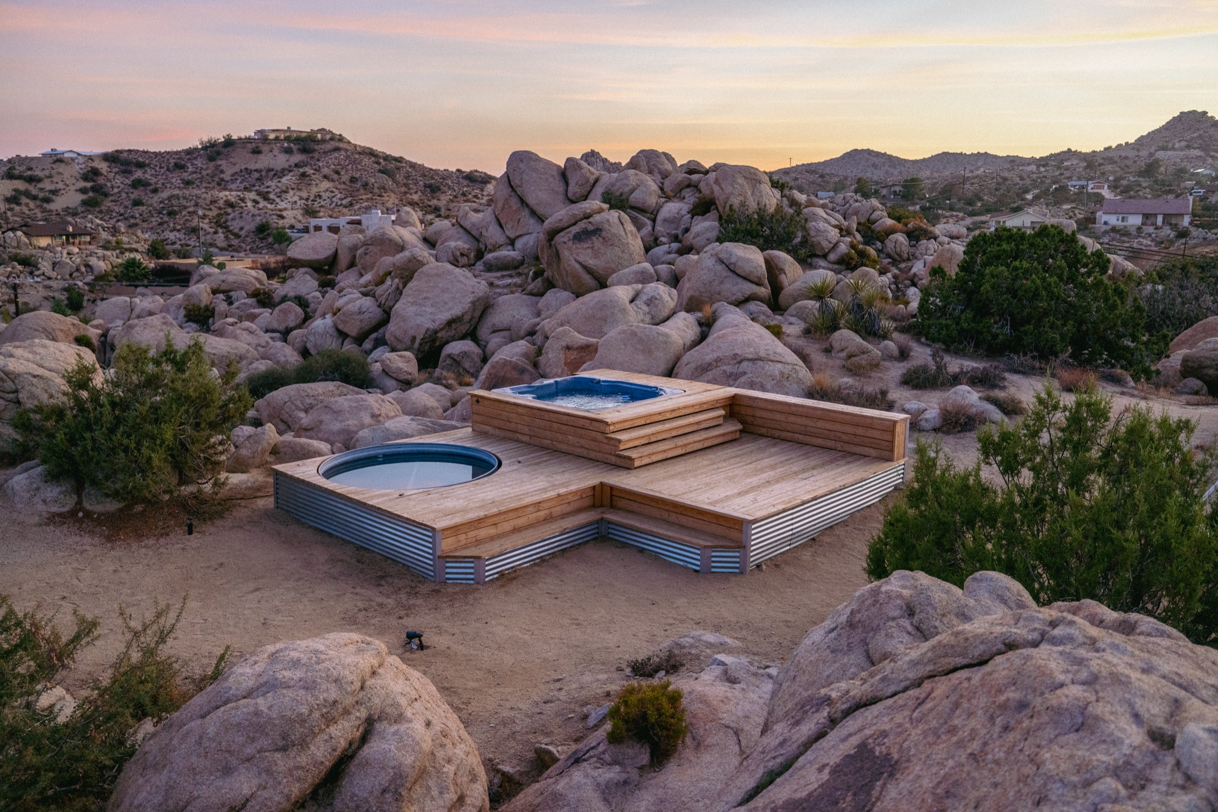 House of Kuna — desert retreat among boulders at dusk